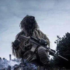 DTNVS-MG | Gen 3 White Phosphor W/ 2700 FOM -Tactical Equipment Soldier in hiding wearing a helmet with the Act in Black DTNVS MG Binocular attached 5b7b092c 6cab 4d93 aaec 59ee177a1ac0