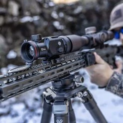 IRay Mate MAH50 | 50mm Clip-On Thermal W/ 2400 Yard Range 33 IRay Mate MAH50 | 50mm Clip-On Thermal W/ 2400 Yard Range -Tactical Equipment gallery image hunter looking through rifle scope equipped with iray mate mah50