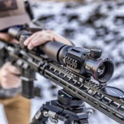 IRay Mate MAH50 | 50mm Clip-On Thermal W/ 2400 Yard Range 34 IRay Mate MAH50 | 50mm Clip-On Thermal W/ 2400 Yard Range -Tactical Equipment gallery image hunter looking through rifle scope with iray mate mah50 thermal imaging device