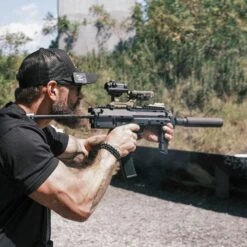 GBRS Group Hydra V2 Mount Kit | Made In USA 21 GBRS Group Hydra V2 Mount Kit | Made In USA -Tactical Equipment man in shooting range aiming rifle equipped with aimpoint duty rds fde gbrs group hydra v2 mount